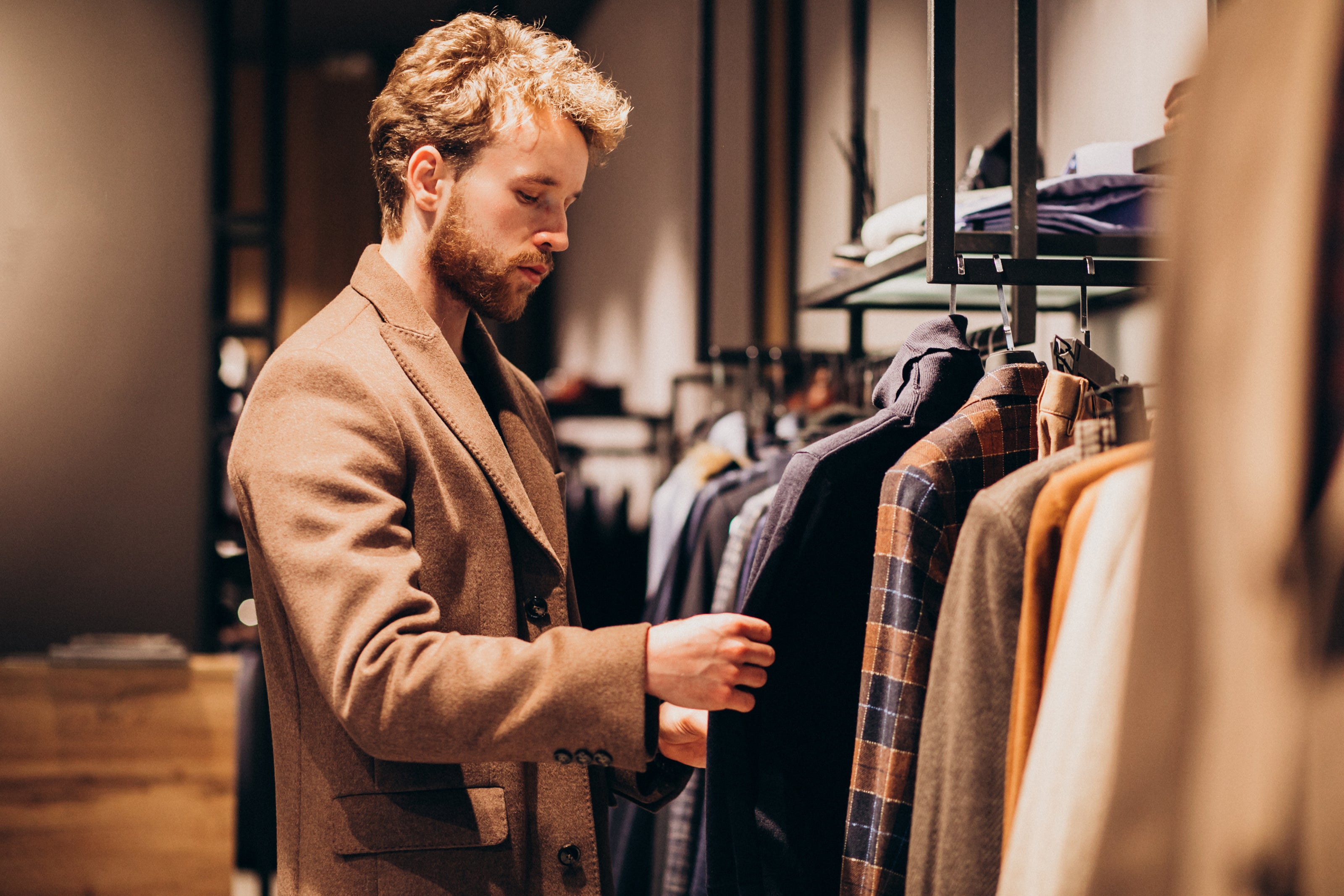 young-handsome-man-choosing-clothes-shop_1.jpg